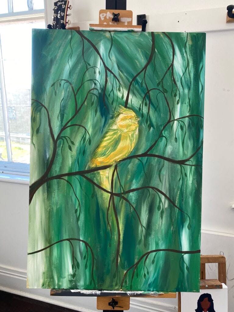 A painting in progress of a bird on a branch